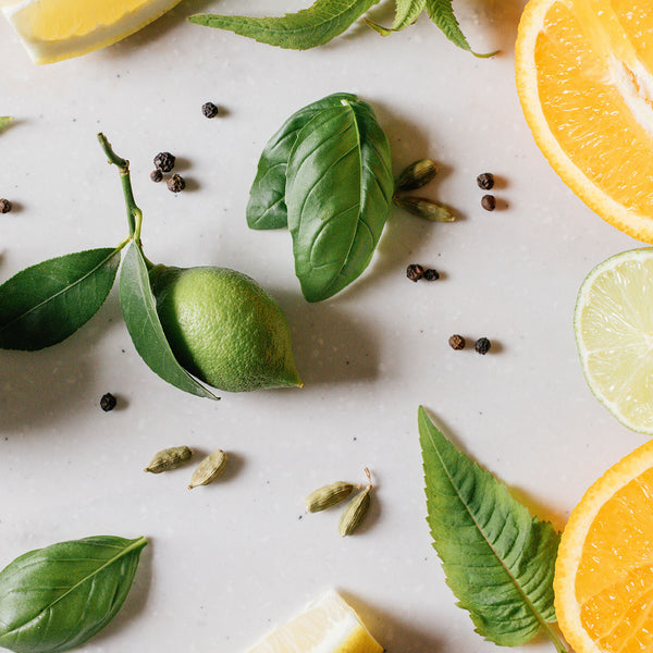 Fresh lemons, limes and cardamon to showcase the ingredients of the 'Pomelo Bitters' citrus scented candle. 